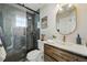 Modern bathroom showcasing walk-in shower with rainfall shower head, decorative tile, and floating wood vanity at 8256 E 28Th Dr, Denver, CO 80238