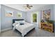 Bright bedroom featuring a cozy bed, natural light from windows, and decorative bookshelf at 8256 E 28Th Dr, Denver, CO 80238