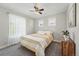 Comfortable bedroom featuring bright yellow bedding, natural light from large windows, and wood dresser at 8256 E 28Th Dr, Denver, CO 80238
