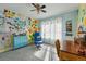 Cheerful bedroom featuring unique decor, light-colored walls, and natural light from a large window at 8256 E 28Th Dr, Denver, CO 80238