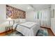 Bright bedroom featuring a large colorful picture and a window with sheer curtains at 8256 E 28Th Dr, Denver, CO 80238