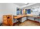 Basement craft room featuring a work station with a sink, storage cabinets, and lots of natural light at 8256 E 28Th Dr, Denver, CO 80238