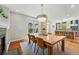 Open-concept dining area with hardwood floors flows into a modern kitchen at 8256 E 28Th Dr, Denver, CO 80238