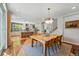This dining room is adjacent to a modern kitchen and a stairway at 8256 E 28Th Dr, Denver, CO 80238