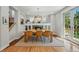 Bright dining room features hardwood floors, a fireplace, and a stylish chandelier at 8256 E 28Th Dr, Denver, CO 80238