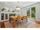 Bright dining room with fireplace, large windows, and backyard access at 8256 E 28Th Dr, Denver, CO 80238