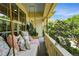 Relaxing covered porch featuring a swing with comfortable pillows, and outdoor plants at 8256 E 28Th Dr, Denver, CO 80238
