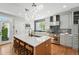 Modern kitchen with quartz countertops, stainless appliances and an eat-in island at 8256 E 28Th Dr, Denver, CO 80238