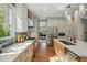 Modern kitchen with quartz countertops, stainless appliances and access to the living room at 8256 E 28Th Dr, Denver, CO 80238