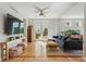 Sun-drenched living room with stylish sectional sofa and hardwood floors with french doors at 8256 E 28Th Dr, Denver, CO 80238