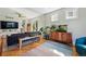 Bright living room featuring hardwood floors, a comfortable sofa, and modern furnishings at 8256 E 28Th Dr, Denver, CO 80238