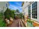 Patio with stone pavers, outdoor seating, umbrella, and string lights for a backyard retreat at 8256 E 28Th Dr, Denver, CO 80238