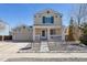 Charming two-story home with a welcoming front porch and well-maintained landscaping at 335 Tynan Dr, Erie, CO 80516