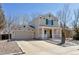 Two-story home with attached garage, well-kept lawn, and inviting front porch at 335 Tynan Dr, Erie, CO 80516
