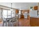 Bright kitchen featuring white appliances, wood cabinets, and adjacent dining area at 335 Tynan Dr, Erie, CO 80516