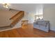 Inviting living room with hardwood floors, staircase, and comfortable seating at 335 Tynan Dr, Erie, CO 80516