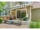 Serene back patio featuring comfortable seating, a retractable awning, and lush greenery at 1190 Telleen Ave, Erie, CO 80516