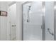 Clean bathroom showcasing a glass-enclosed shower with white subway tile and accessible grab bars at 1190 Telleen Ave, Erie, CO 80516