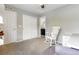 Spare bedroom with chair, desk, rocker, ceiling fan, and closet with bathroom access at 1190 Telleen Ave, Erie, CO 80516