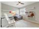 Spare bedroom with shelves, chair and desk with a ceiling fan and large window at 1190 Telleen Ave, Erie, CO 80516