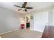 Cozy bedroom featuring neutral paint, ceiling fan, and closet with access to a bathroom at 1190 Telleen Ave, Erie, CO 80516