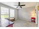 Well-lit bedroom with neutral decor, ceiling fan, and ample natural light from large windows at 1190 Telleen Ave, Erie, CO 80516