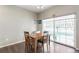 Bright dining area featuring hardwood floors, wooden table and chairs, and a large window with natural light at 1190 Telleen Ave, Erie, CO 80516