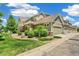 Beautifully landscaped townhome featuring a garage and a well-maintained green lawn at 1190 Telleen Ave, Erie, CO 80516