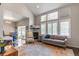 Bright living room featuring high ceilings, large windows, and stylish furniture at 1190 Telleen Ave, Erie, CO 80516