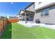 Spacious backyard with artificial turf, a patio, a grill, and a privacy fence at 9835 Uravan St, Commerce City, CO 80022