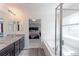 Spacious bathroom featuring double vanity, granite countertop, soaking tub and walk-in shower at 9835 Uravan St, Commerce City, CO 80022