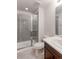 Beautiful bathroom featuring glass enclosed shower with gray tile surround and a modern vanity at 9835 Uravan St, Commerce City, CO 80022