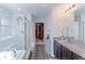 Bright bathroom features a glass shower door, a soaking tub and granite countertops at 9835 Uravan St, Commerce City, CO 80022
