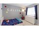 bedroom with personalized decor, featuring a bed and a dresser at 9835 Uravan St, Commerce City, CO 80022