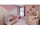 Lovely Bedroom with a crib, chair, and charming decor at 9835 Uravan St, Commerce City, CO 80022