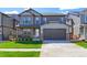 Charming two-story home with a well-manicured lawn and a two-car garage at 9835 Uravan St, Commerce City, CO 80022