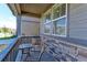 Cozy front porch with chairs and a table, perfect for relaxing outdoors at 9835 Uravan St, Commerce City, CO 80022