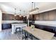 Modern kitchen features dark cabinets, granite countertops, stainless steel appliances and an island with a breakfast bar at 9835 Uravan St, Commerce City, CO 80022