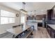 Bright eat-in kitchen with dark cabinets, granite countertops, stainless appliances, and contemporary pendant lighting at 9835 Uravan St, Commerce City, CO 80022