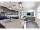 Modern kitchen with a large island, open to the dining and living area at 9835 Uravan St, Commerce City, CO 80022