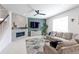Comfortable living room with fireplace, large couch, and bright natural light at 9835 Uravan St, Commerce City, CO 80022