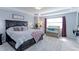 Serene main bedroom with tray ceiling, plush carpeting, and ample natural light at 9835 Uravan St, Commerce City, CO 80022