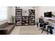 Spacious office area with bookshelves, a comfortable sofa, and ample desk space at 9835 Uravan St, Commerce City, CO 80022