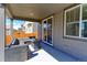 Covered outdoor patio area with comfortable seating, perfect for relaxing or entertaining at 9835 Uravan St, Commerce City, CO 80022
