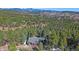 Stunning aerial view of a mountain home nestled among trees at 22683 Hagler Dr, Golden, CO 80401