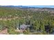 Aerial shot of a house nestled in a lush forest, offering privacy and tranquility at 22683 Hagler Dr, Golden, CO 80401