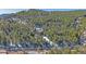 Aerial view of home nestled in a serene, tree-filled landscape with snow on the ground at 22683 Hagler Dr, Golden, CO 80401