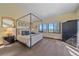 Bright bedroom with a four-poster bed, ample natural light, and scenic views at 22683 Hagler Dr, Golden, CO 80401