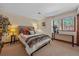 Inviting bedroom with neutral walls, plush carpet, decorative pillows, and a window with natural light at 22683 Hagler Dr, Golden, CO 80401
