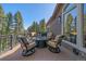 Outdoor deck area features a fire pit and four chairs, perfect for relaxing and enjoying the mountain views at 22683 Hagler Dr, Golden, CO 80401
